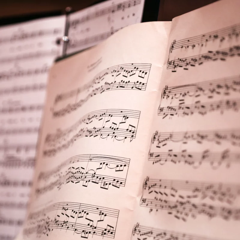 Syllable stress is the music of English. A close-up of music paper on a stand.